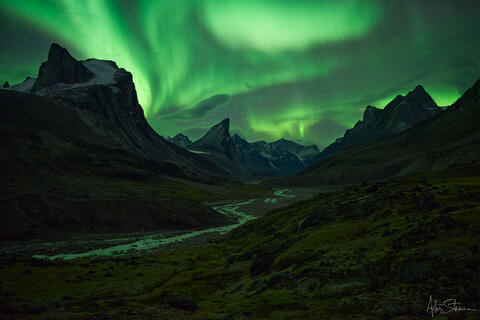 Aurora borealis over Mt. Thor in Canadian Arctic.
