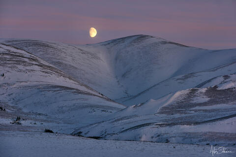 Moonrise over the mountains in Canadian Arctic.