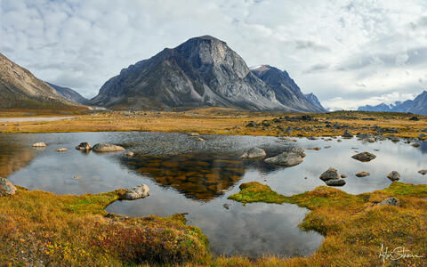 Reflection of a mountain in a small arctic pond.